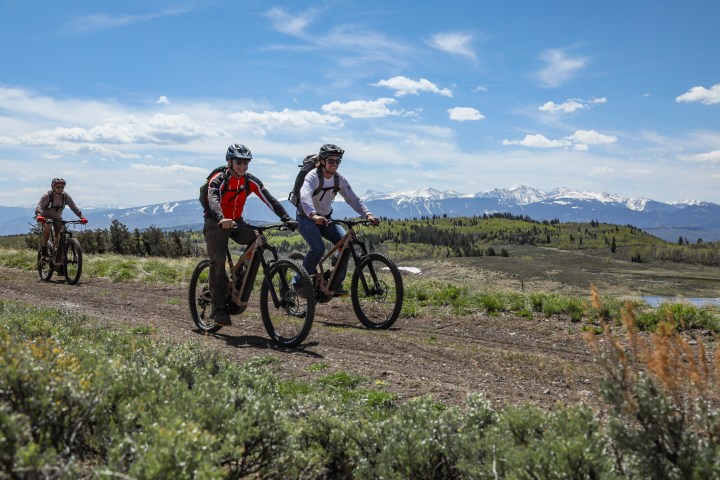 a man riding a bike down a dirt road