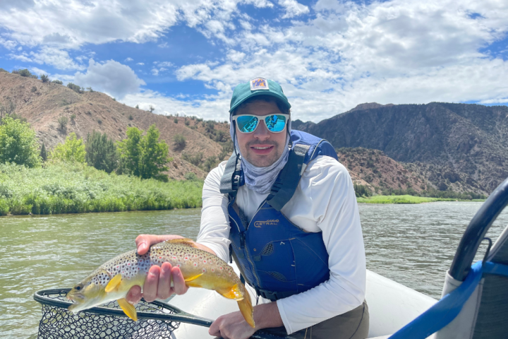 a person holding a fish in the water