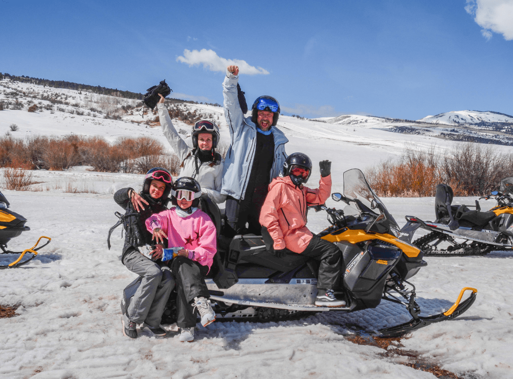 where-can-you-snowmobile-in-colorado_9817db a group of people sitting in the snow